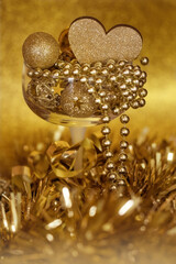 Festive looking golden items in a wine glass