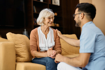 Happy mature woman talks to caregiver at nursing home. - obrazy, fototapety, plakaty