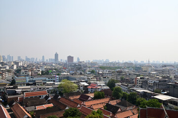 Obraz premium BANGKOK, THAILAND - April 12, 2023 : Landscape View of Bangkok City and Thai Buddhist Temple with Blue sky with white cloud. Clear day and good weather in the morning.
