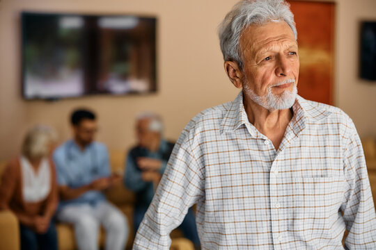 Pensive elderly man in nursing home looking away.