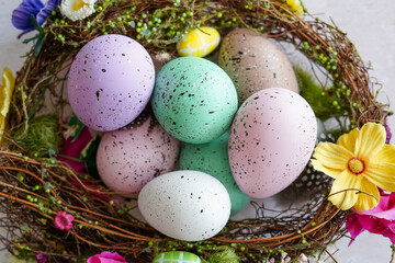 Naklejka na ściany i meble Happy Easter concept. Preparation for holiday. Colorful decorated easter eggs in nest with flowers