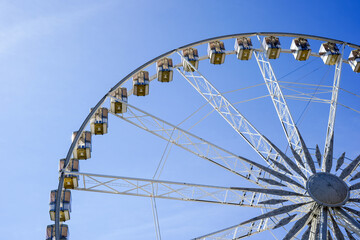 Ferris Wheel Over Blue Sky background