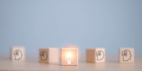 Concept creative idea and innovation. wooden cube block with head human symbol and light bulb icon
