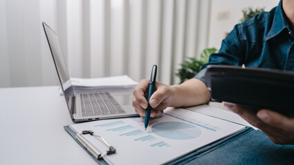 Business bookkeeping with calculator of bookkeeper and household calculating chart graph annual financial account.