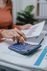Business bookkeeping with calculator of bookkeeper and household calculating chart graph annual financial account.