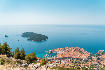 Aerial shot of Dubrovnik Old Town and island Lokrum during bright sunny day