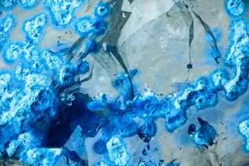 blue shattuckite inclusion inside clear quartz. macro detail texture background. close-up raw rough unpolished semi-precious gemstone