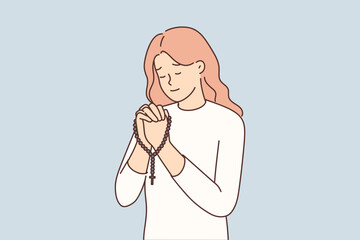 Religious woman pray with rosary 