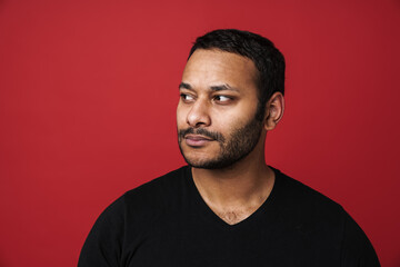 Obraz premium Indian man looking away isolated over red background
