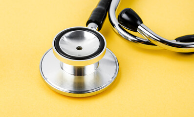 A Stethoscope medical on yellow color Background.