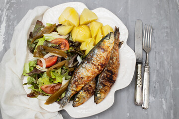 Grilled sardines with boiled potato and fresh salad