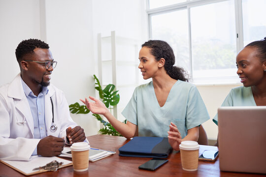 Smiling Medical Professionals Discuss At Doctor Management Meeting, Surgery Prep