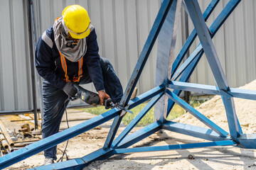 worker to cutting steel in construction site with Reciprocating saw or recip saw, saw used in...