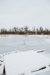 the wooden masonry on the pond is crushed by snow in winter 