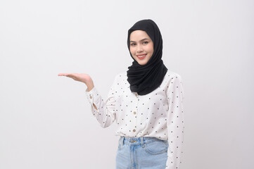 Portrait of beautiful muslim woman with hijab over white background studio.