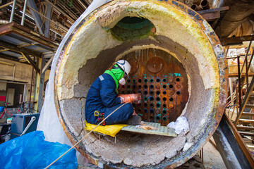 Male worker internal rotary Inspection System (IRIS) construction tube boilers in industrial areas, chemical products, or toxic hazardous