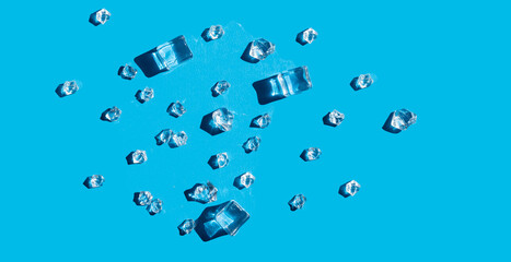 ice on a blue background with hard shadows. cold background