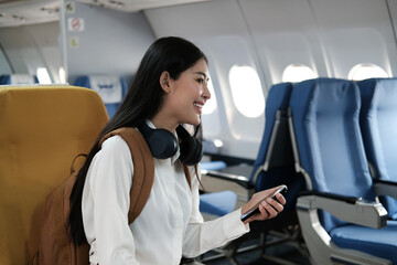 Backpacker asian woman in the airplane while to destination. Travel concept