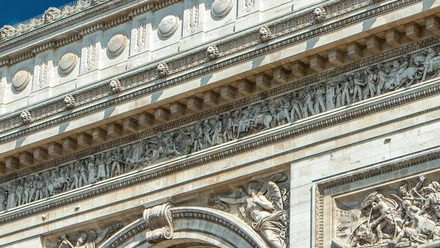 Top part of the Arc de Triomphe (Triumphal Arch of the Star) timelapse is famous monument in Paris, standing at the western end of the Champs-Elyseees. Blue cloudy sky at summer day