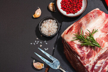 Raw pork loin with spices and herbs. Fresh meat cut, ingredient for cooking protein food