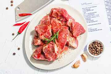 Paper culinary recipe for preparation pork. Raw ingredients includes pork loin pieces, spices, herbs