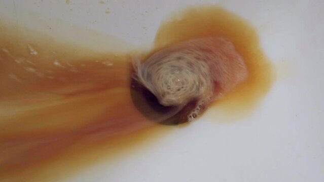 The 4k video of red hair dye flowing down the bathtub drain.