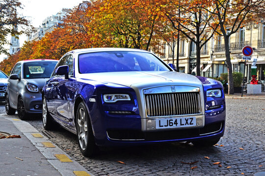 Paris, France - October 26th 2019 : Beautiful silver and blue Rolls-Royce phantom parked in George V avenue.
