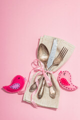 Romantic table setting with handmade birds. Vintage cutlery, fresh flowers, linen napkin