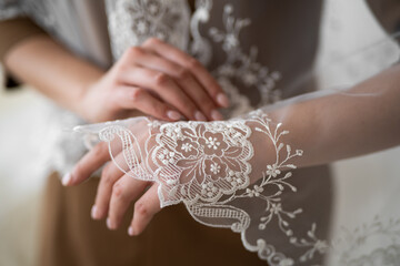 wedding veil close-up of embroidered pattern on hand.