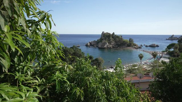 Shot through trees of beach and Isola Bella, Mazzaro, Taormina, Sicily, Italy, Mediterranean, Europe