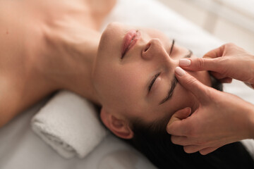 Fototapeta na wymiar Crop masseuse doing massage to client