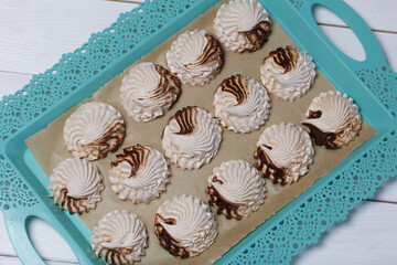 Marshmallow flowers on trays. Homemade zephyr. Close-up.