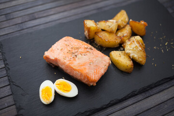 steamed salmon fillet with potato wedges and quail egg