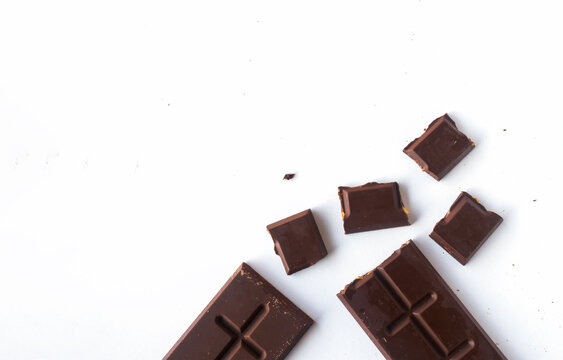 Flat lay composition with delicious chocolate on white table background