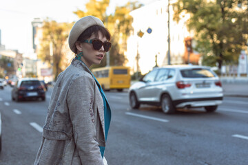 Fototapeta premium Brunette in a beret in the autumn city