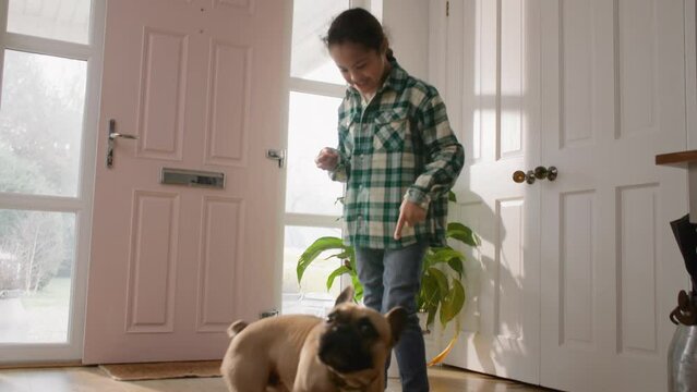 Multiracial boy with Down syndrome training pet dog