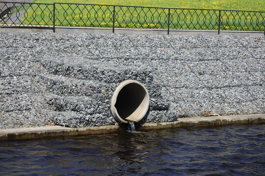 Water outflows in the river through flood drainage system.