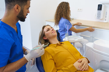 Dental examination of young woman at dental clinic.