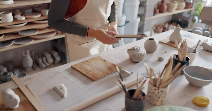 Pottery, sculpture and small business owner woman in her startup retail shop or workshop studio for product design process. Young creativity designer entrepreneur artist with clay production career