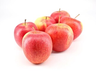 Group of red Fuji apples on white background.