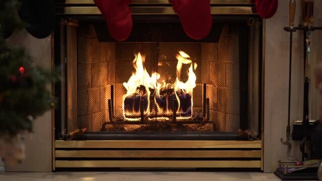 Cozy Fireplace with wax log with Christmas tree and stockings wide angle