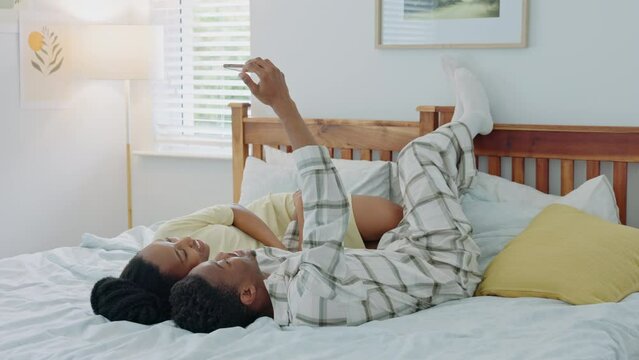 Selfie, kiss and African couple in bed for peace, relax and happiness with a phone together in the morning. Happy, content and black man and woman kissing for a photo on mobile in the bedroom