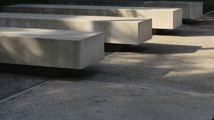 stone benches lined up in the park