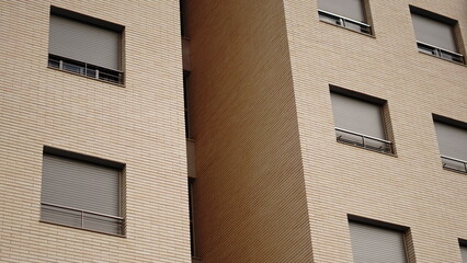 Obraz premium beige brick facade with windows as background