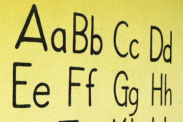 English alphabet on a yellow wall