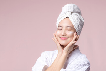 Young asian woman applying facial skincare face cream, cosmetic moisturiser on healthy natural skin...