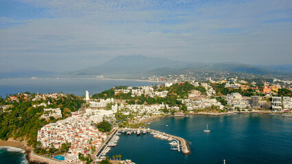 Fototapeta na wymiar Aerial view of Peninsula de Santiago in city Manzanillo, Mexico. Beautiful bitch and luxury hotels and boat and yacht berth