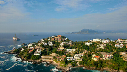 Fototapeta na wymiar Aerial view of Peninsula de Santiago in city Manzanillo, Mexico. Beautiful bitch and luxury hotels and boat and yacht berth
