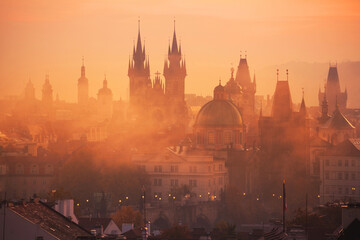 Fototapeta na wymiar Fog over Prague Towers at beautiful sunrise, view from the Mala Strana , City of a Hundred Spires - Prague, Bohemia, Czech Republic at sunrise