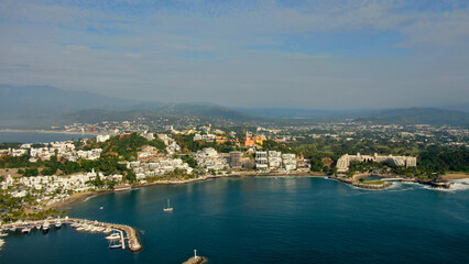 Aerial view of Peninsula de Santiago in city Manzanillo, Mexico. Beautiful bitch and luxury hotels and boat and yacht berth